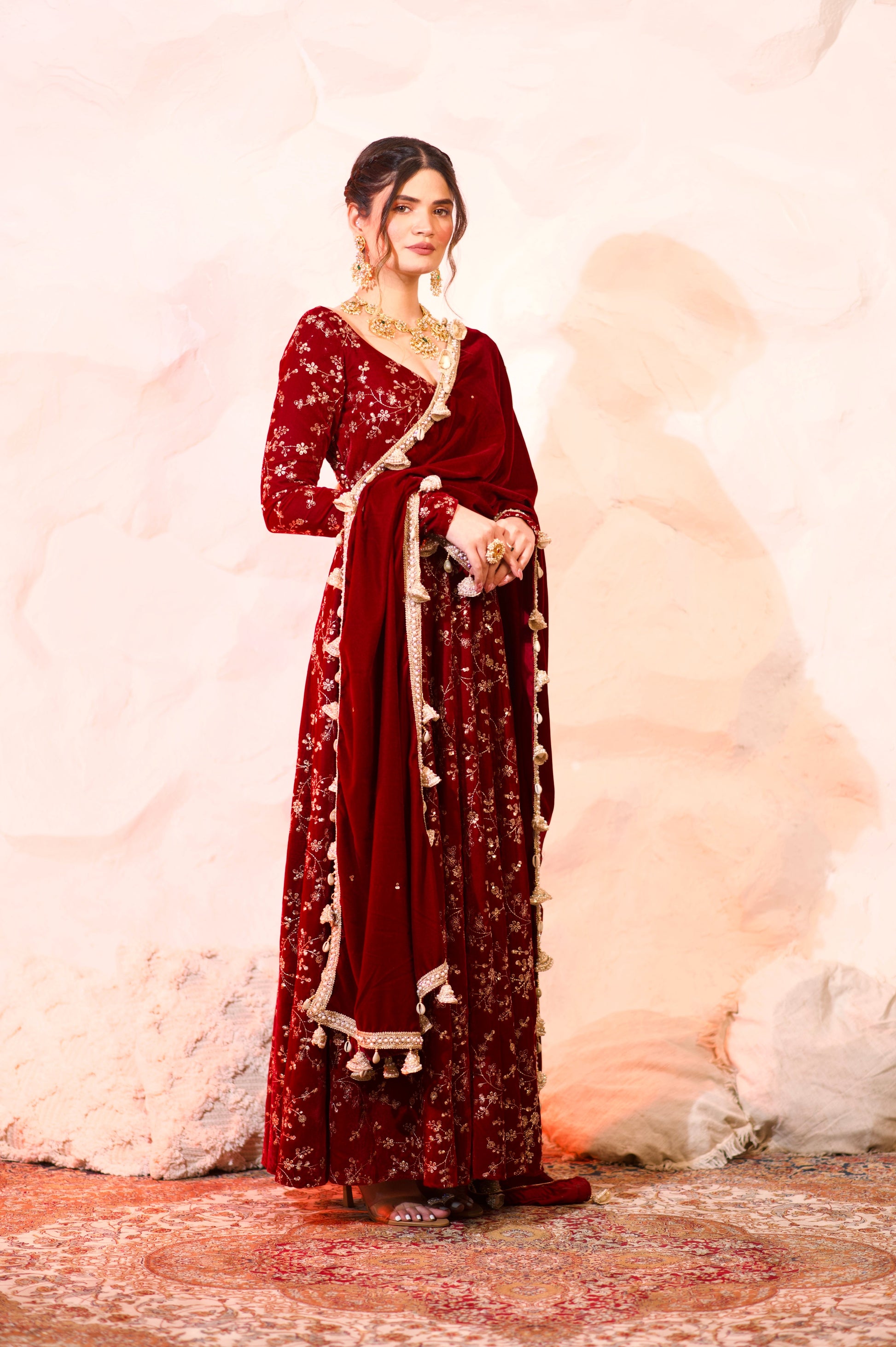 Red velvet Malaika Anarkali dress by Imagine by Shiwali featuring intricate embroidery and a flowing silhouette.
