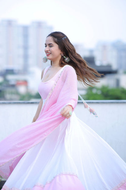 White and pink Meera Anarkali dress by Imagine By Shiwali, featuring intricate embroidery and flowing fabric.