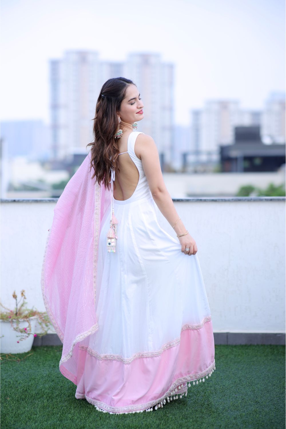 White and pink Meera Anarkali dress by Imagine By Shiwali, featuring intricate embroidery and flowing fabric.