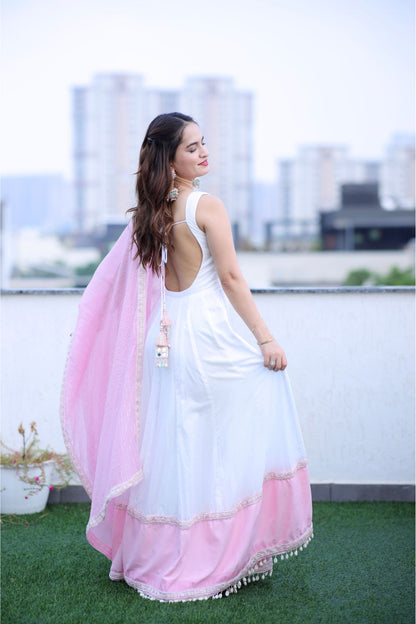 White and pink Meera Anarkali dress by Imagine By Shiwali, featuring intricate embroidery and flowing fabric.