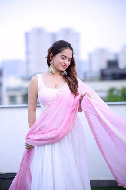 White and pink Meera Anarkali dress by Imagine By Shiwali, featuring intricate embroidery and flowing fabric.
