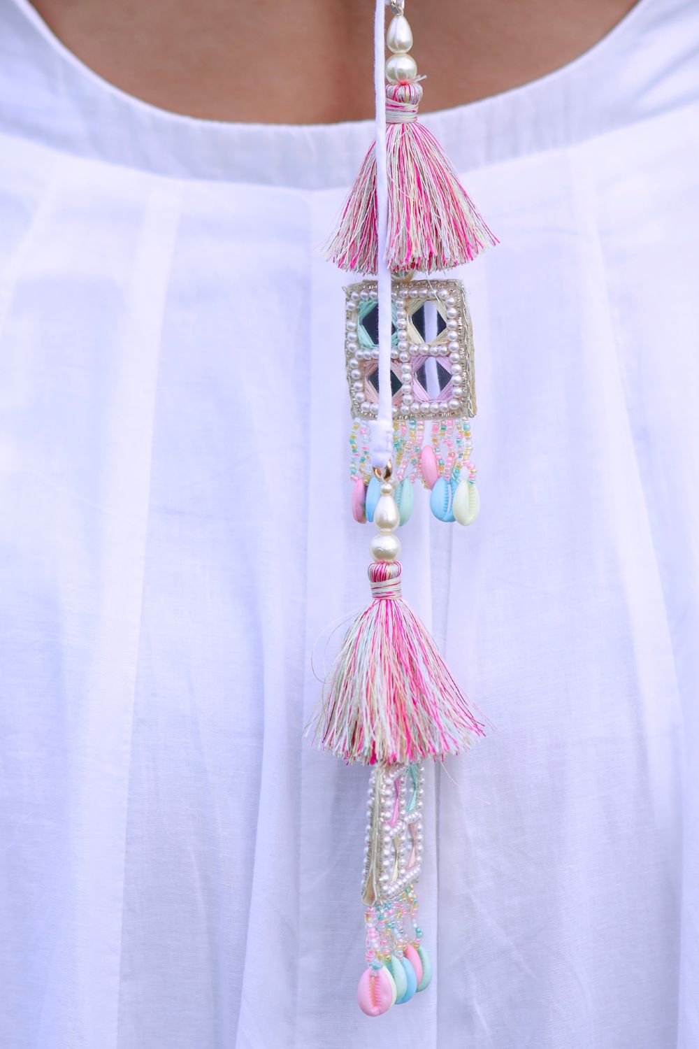 White and pink Meera Anarkali dress by Imagine By Shiwali, featuring intricate embroidery and flowing fabric.