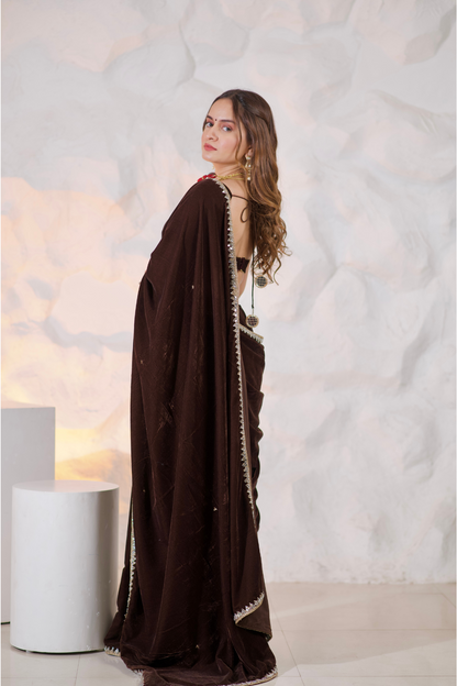 Brown velvet saree by Imagine Shiwali featuring intricate draping and elegant texture.