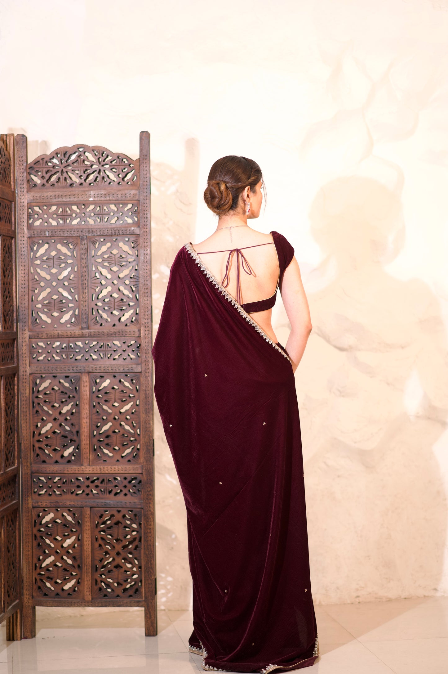 Nazia Wine Velvet Saree by Imagine By Shiwali displayed draped, showcasing rich wine velvet fabric and elegant design.