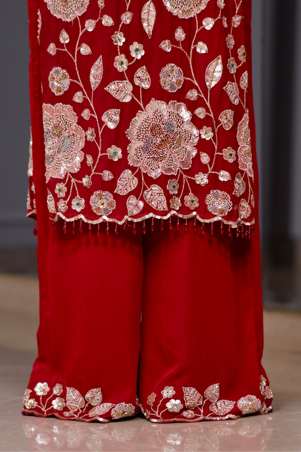 Red straight suit from Radha collection by Imagine By Shiwali, featuring a traditional design with intricate details.