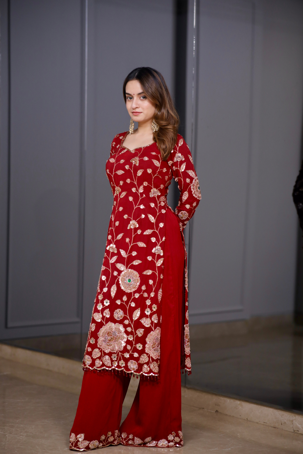 Red straight suit from Radha collection by Imagine By Shiwali, featuring traditional ethnic design and vibrant fabric details.