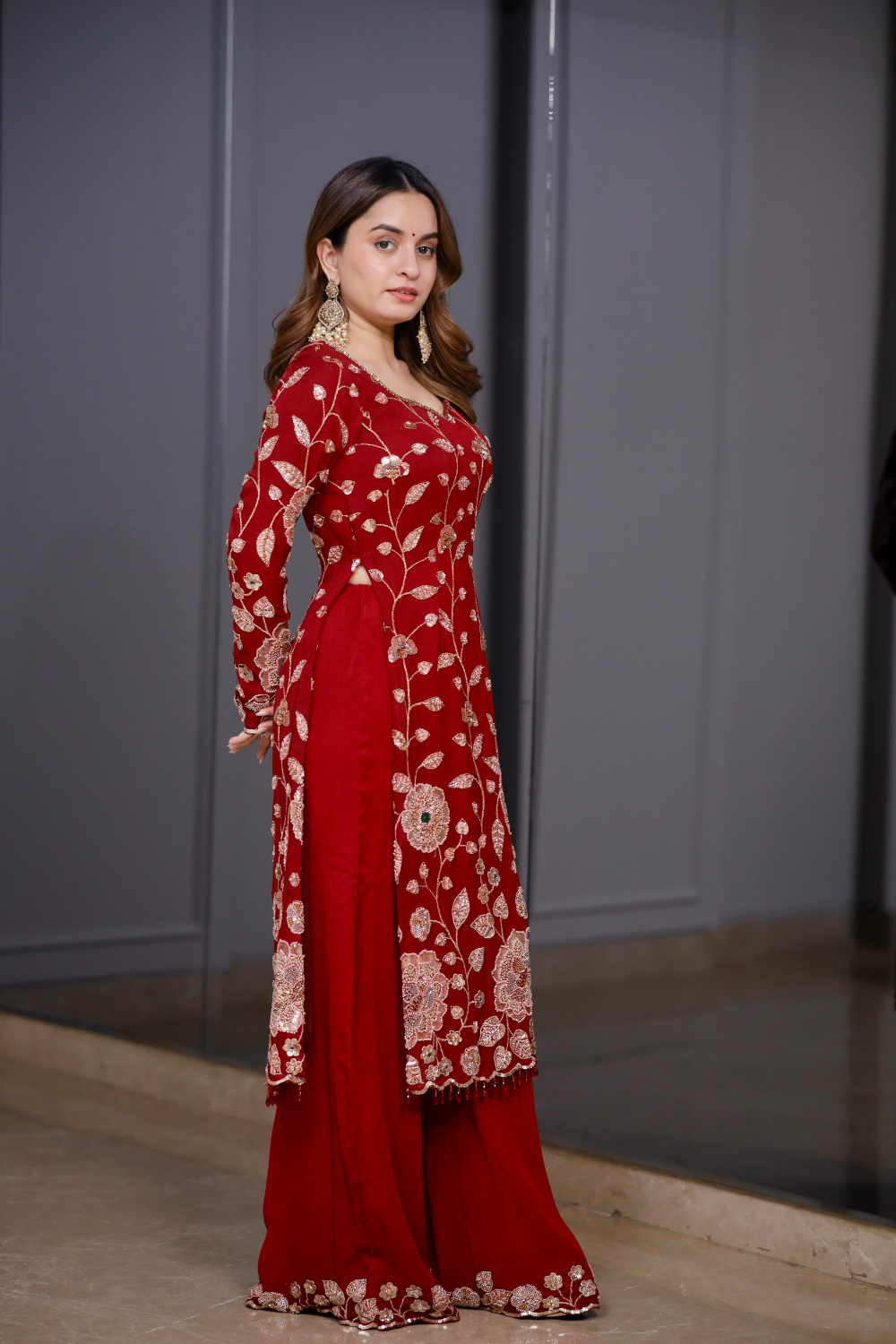 Red straight suit from Radha collection by Imagine By Shiwali, featuring a vibrant red fabric with traditional design details.