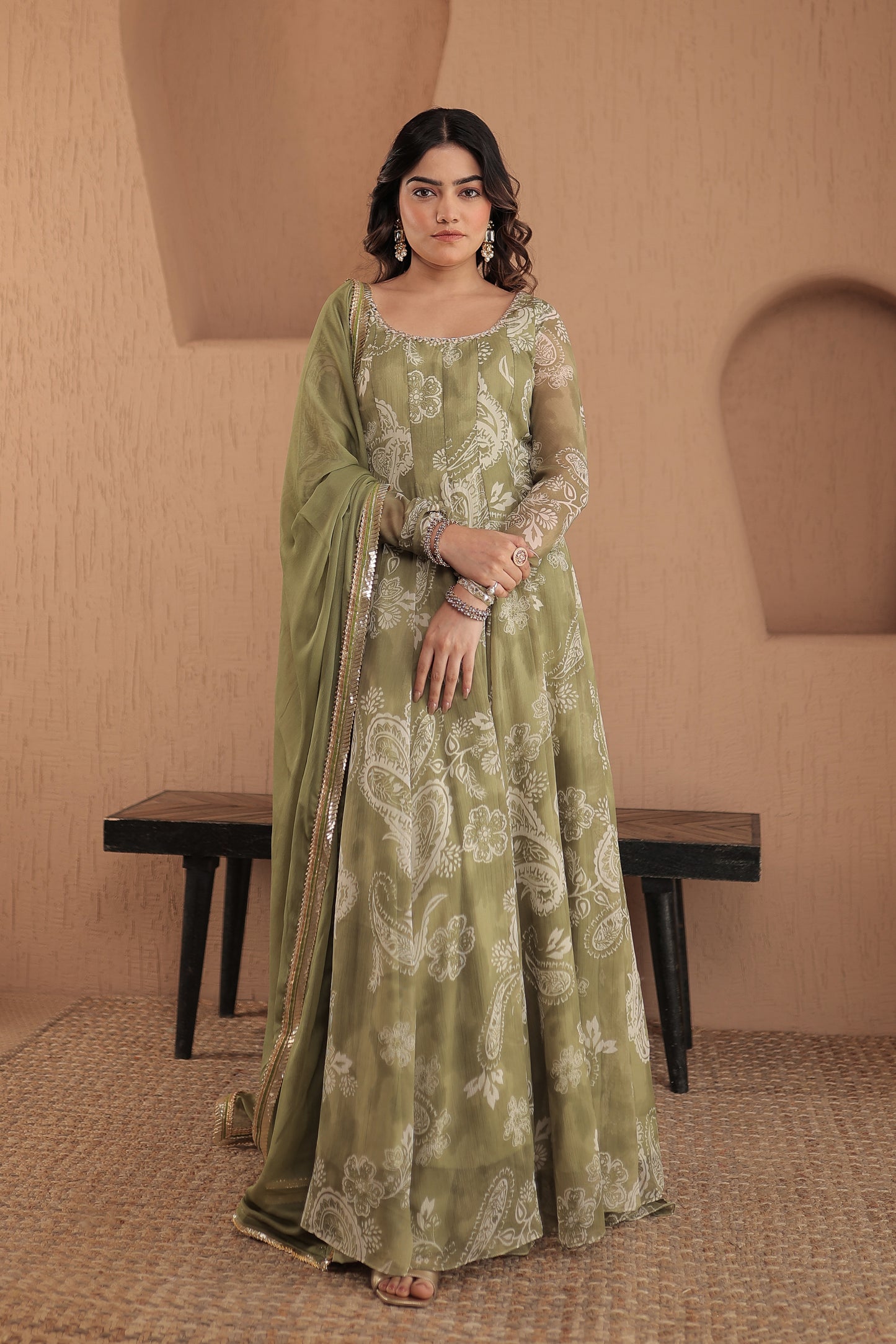 Green chiffon Rasiya anarkali dress by Imagine By Shiwali featuring intricate embroidery and flowing fabric.