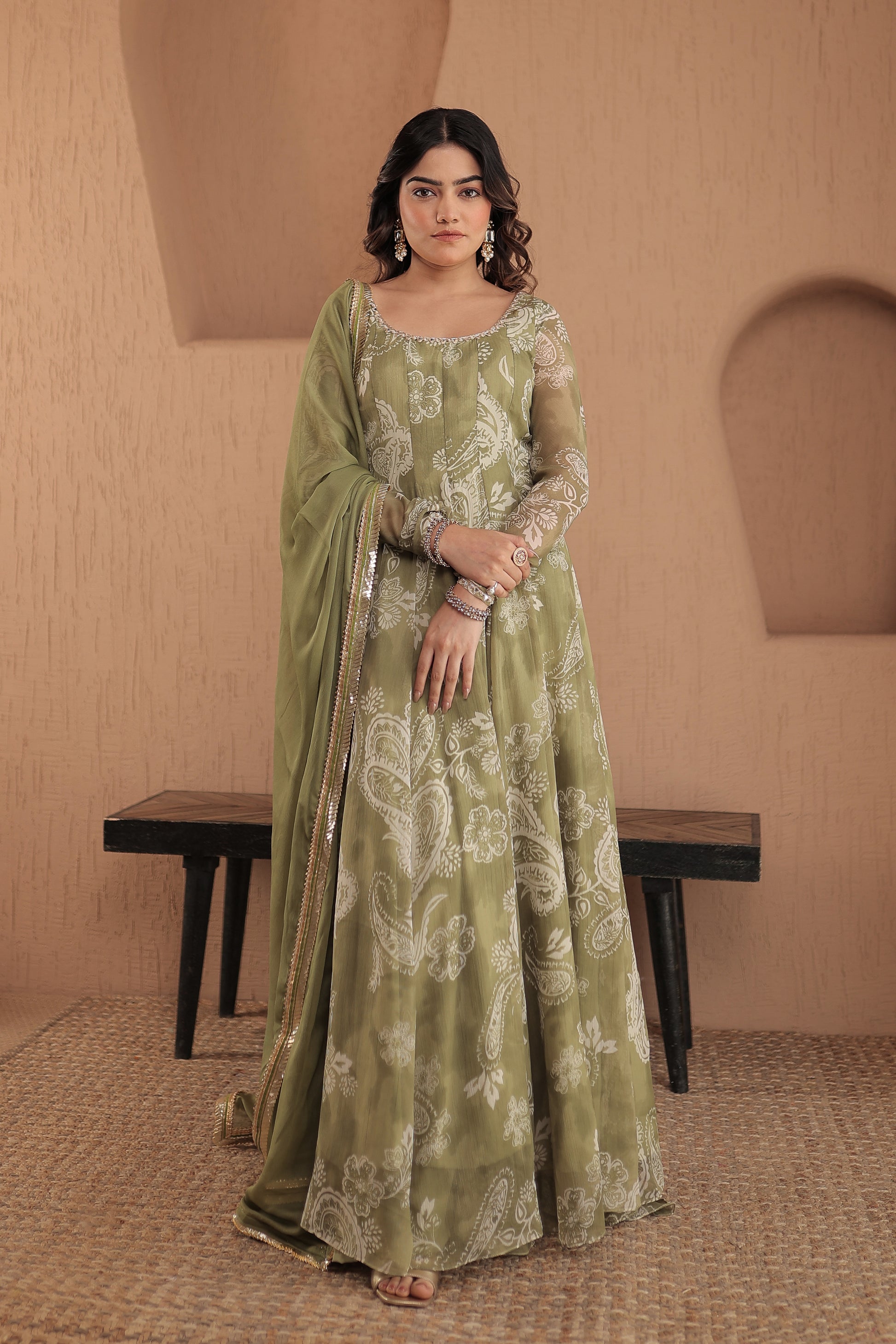 Green chiffon Rasiya anarkali dress by Imagine By Shiwali featuring intricate embroidery and flowing fabric.