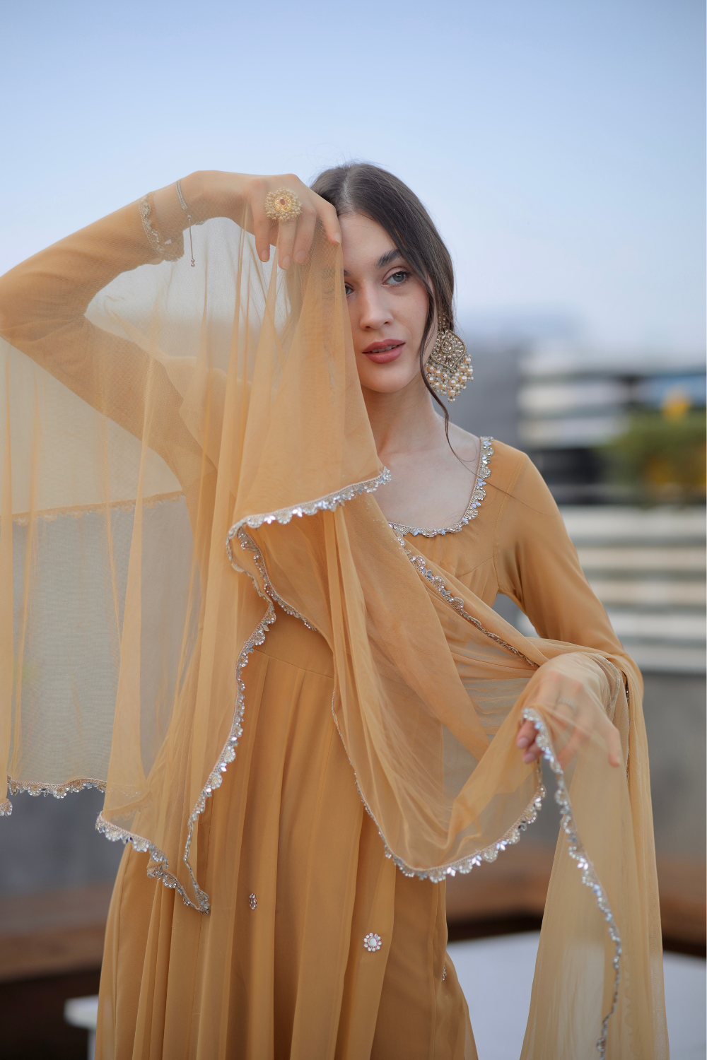 Brown Sharwari Anarkali by Imagine By Shiwali featuring intricate embroidery and flowing fabric.