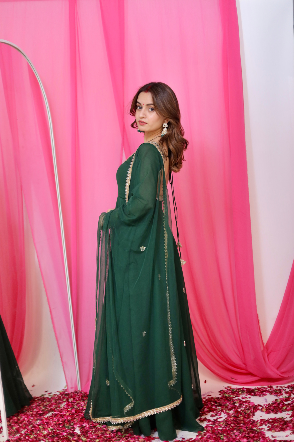 Green Sharwari Anarkali dress by Imagine By Shiwali, featuring intricate embroidery and flowing fabric, worn by a model.