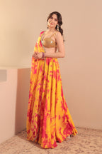 Yellow and red tie-dye Sia Lehenga Set by Imagine By Shiwali, featuring vibrant traditional Indian embroidery and flowing fabric.