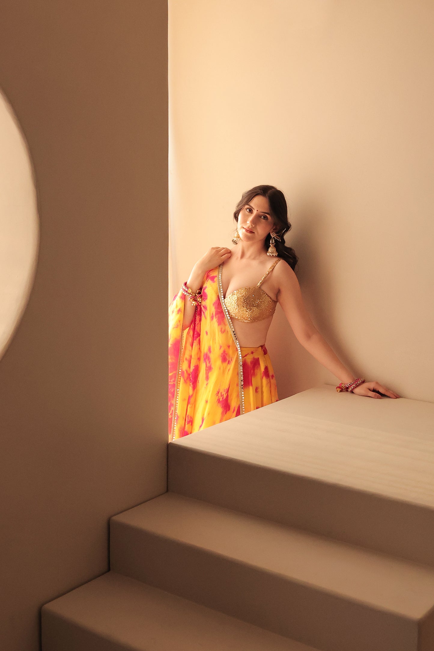 Yellow and red tie-dye lehenga set from Imagine By Shiwali featuring traditional design and vibrant fabric details.