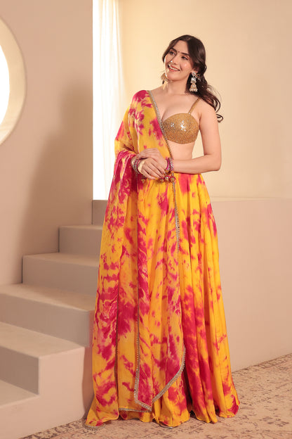 Yellow and red tie-dye Sia Lehenga Set by Imagine By Shiwali, featuring traditional embroidery and vibrant fabric.