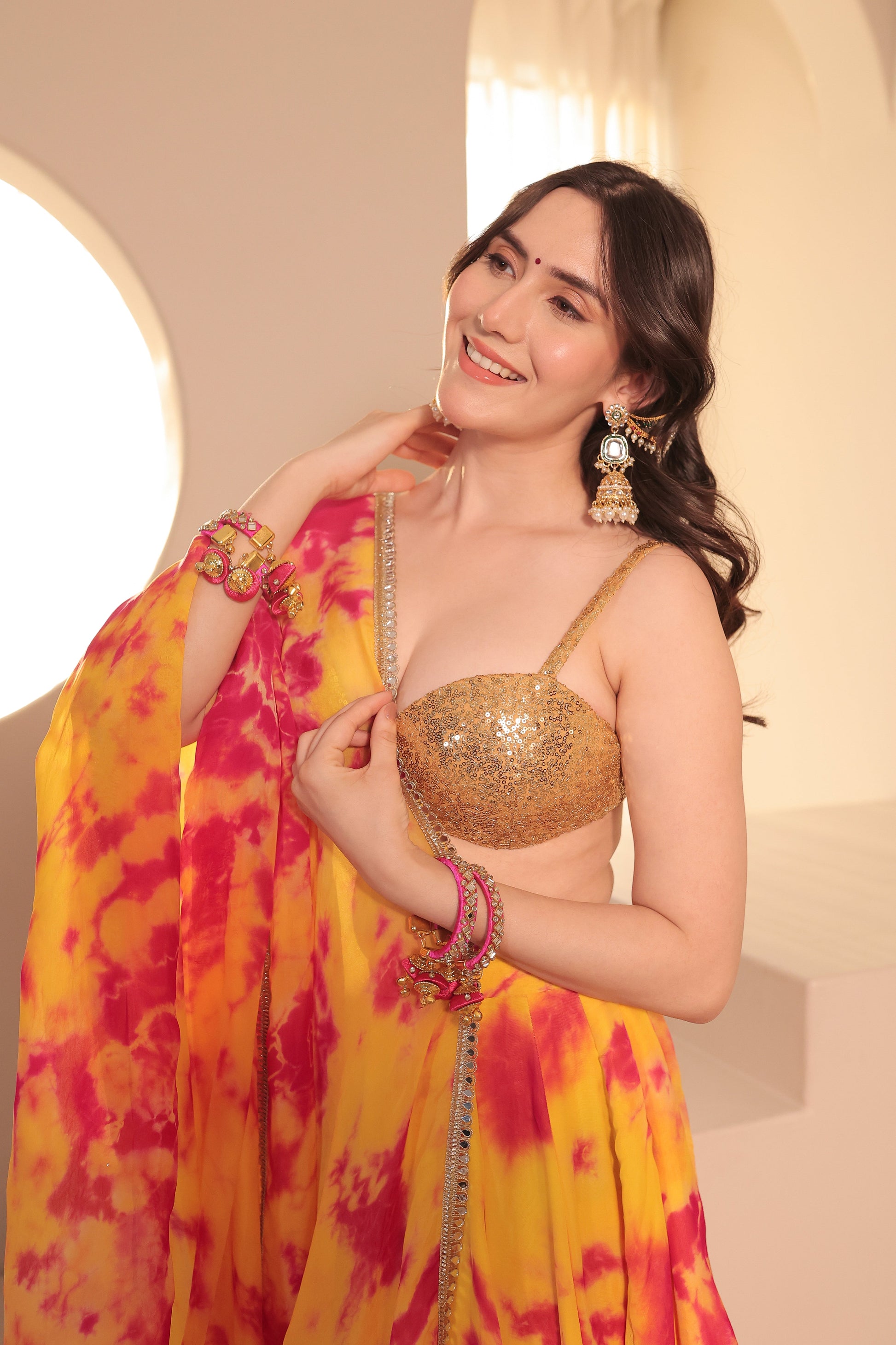 Yellow and red tie-dye Sia Lehenga Set by Imagine By Shiwali, featuring traditional Indian bridal or festive attire.