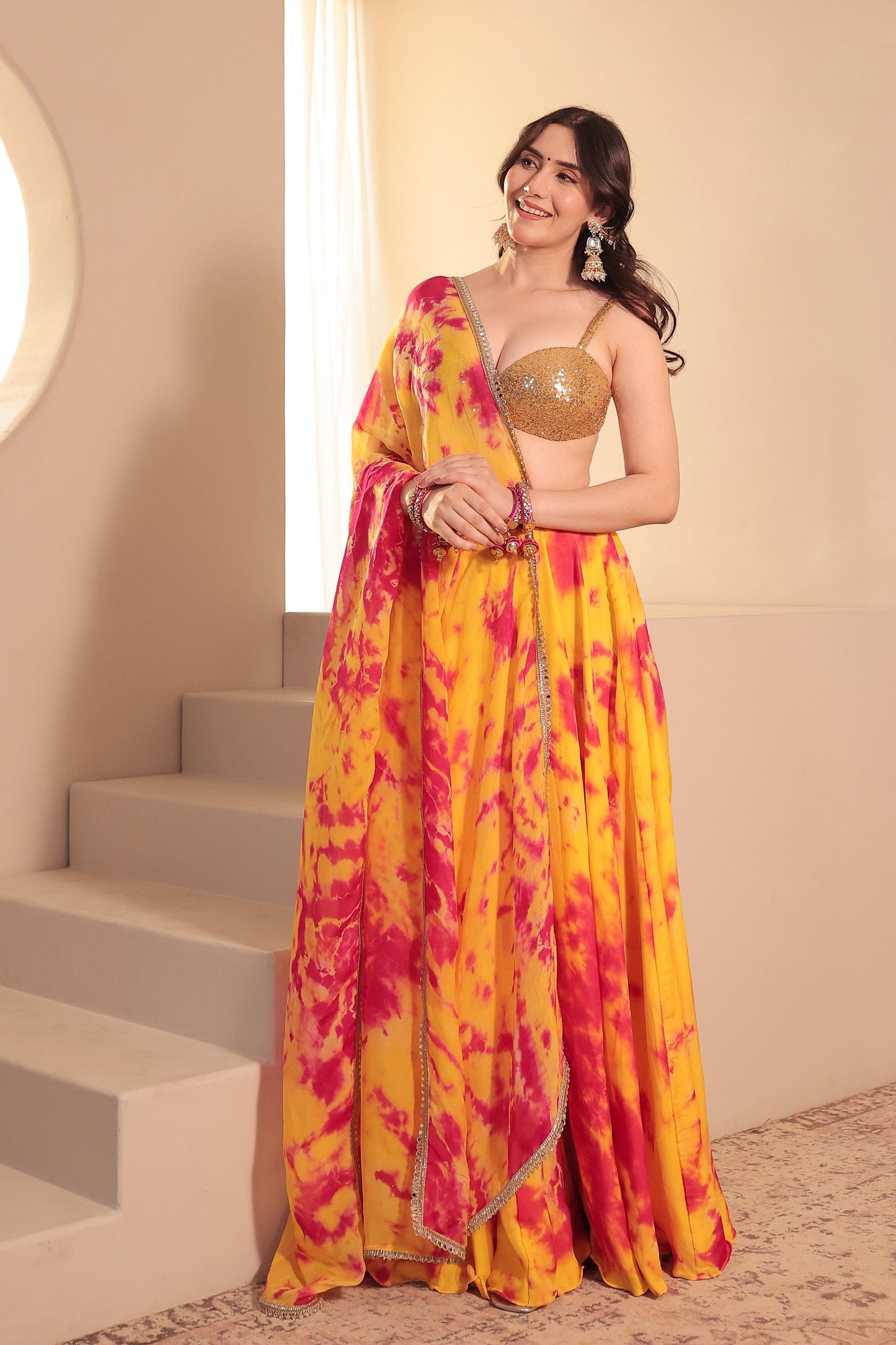Yellow and red tie-dye lehenga set by Imagine By Shiwali featuring traditional craftsmanship and vibrant colors.