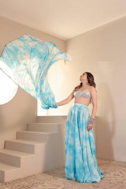 White and blue Sia Tye-Dye Lehnga Set by Imagine By Shiwali, featuring traditional embroidery and vibrant tie-dye patterns.