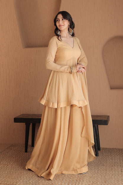 Imagine by Shiwali Suraiya brown peplum suit with intricate embroidery and matching pants, styled for elegant traditional wear.