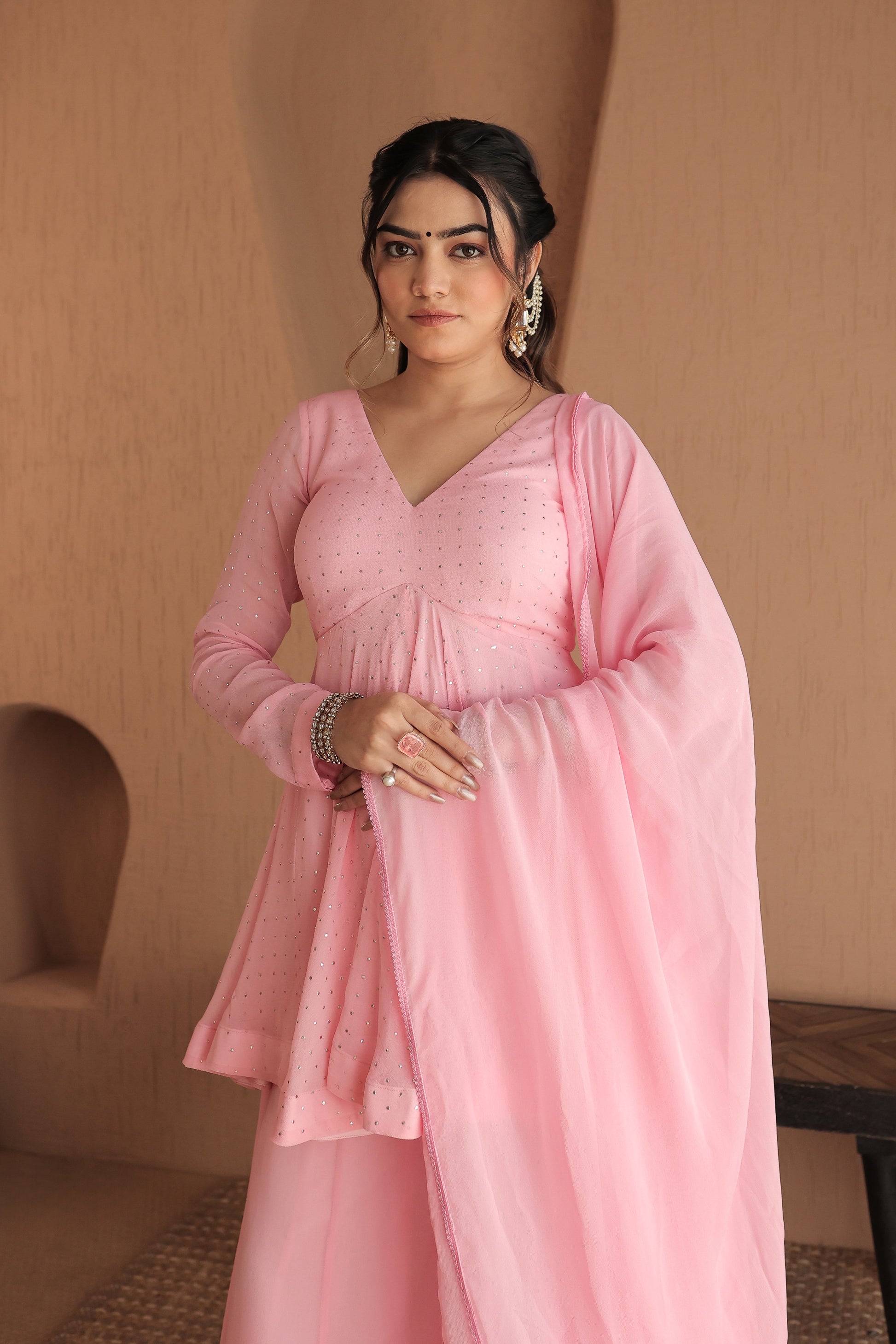Pink Suraiya peplum suit by Imagine by Shiwali featuring intricate embroidery and a stylish, traditional design.