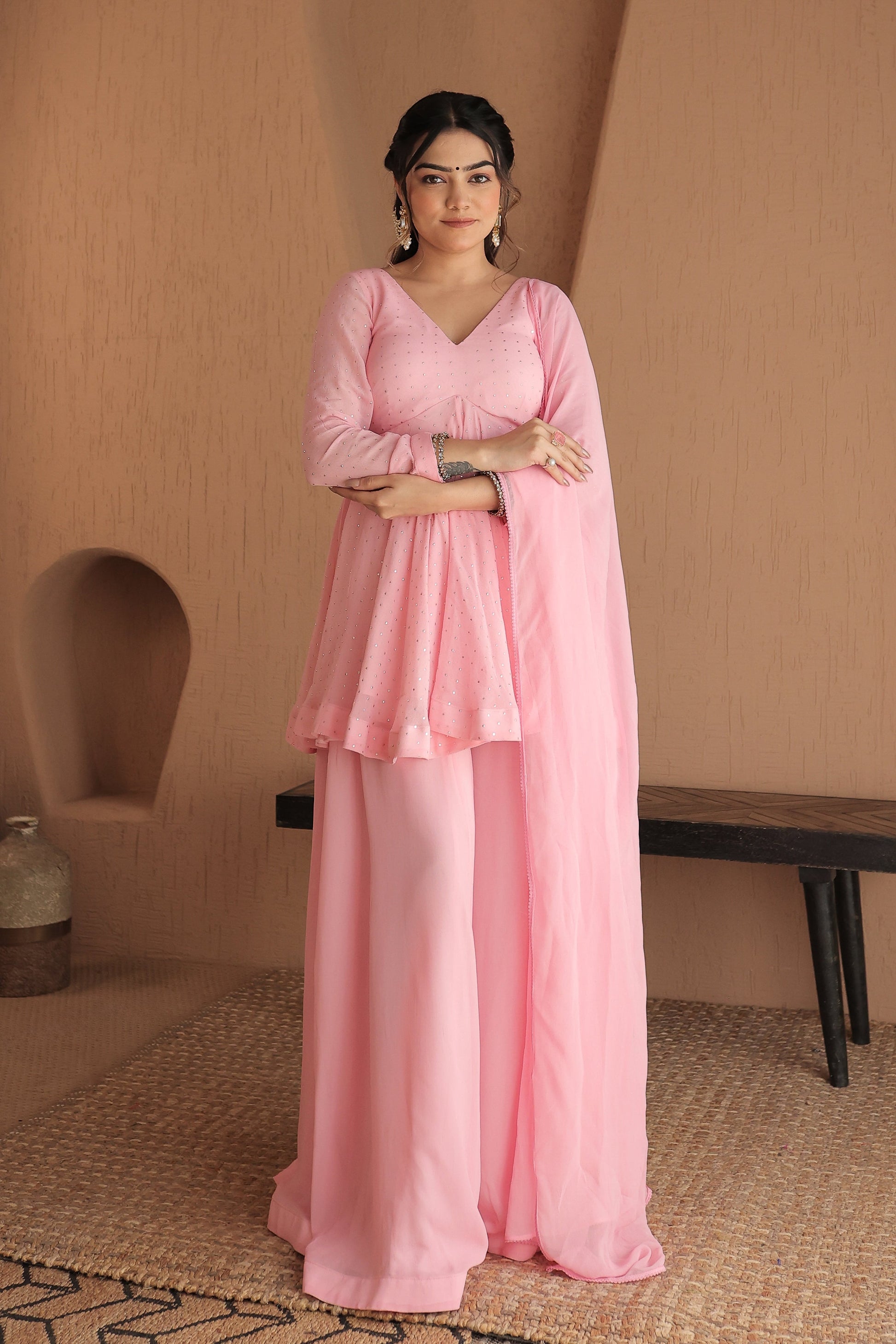 Pink Suraiya peplum suit by Imagine By Shiwali with intricate embroidery and flowy fabric, showcased on a mannequin.