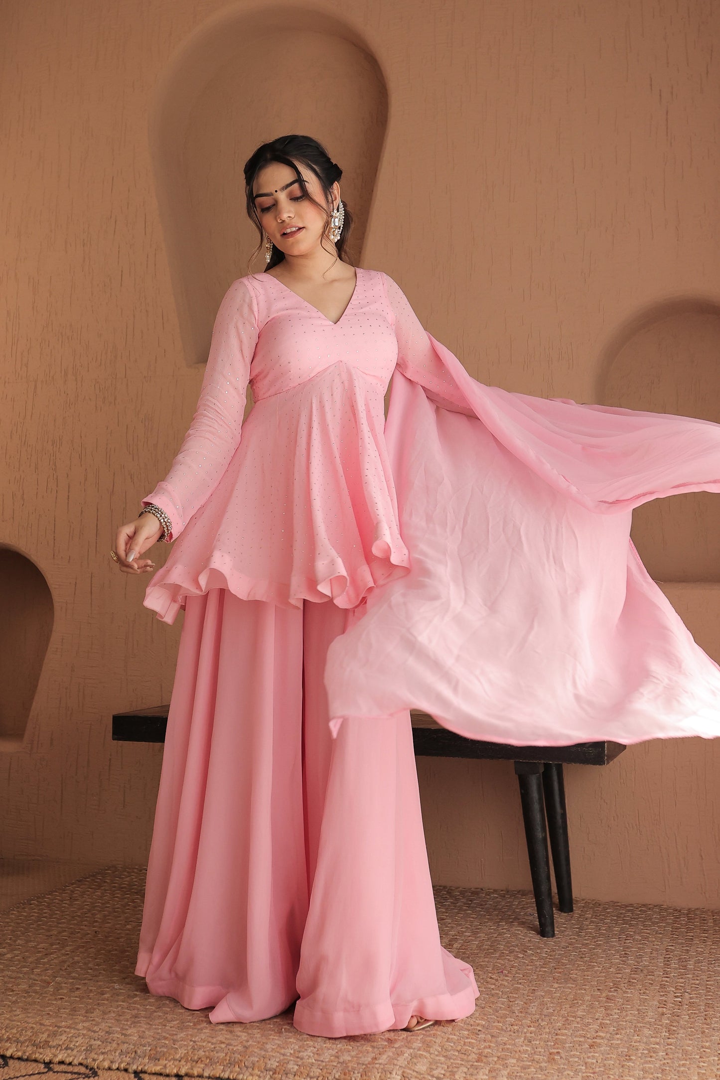 Pink Suraiya peplum suit by Imagine By Shiwali, featuring intricate embroidery and a flowing, elegant design.