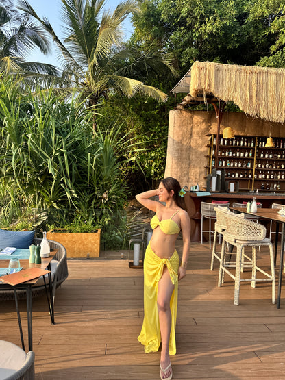 Yellow bikini with wrap skirt set by Imagine By Shiwali, featuring a stylish two-piece swimsuit and matching skirt.