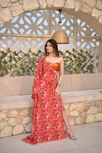 Red floral Tripti kaftan by Imagine By Shiwali featuring flowing fabric and vibrant floral patterns.