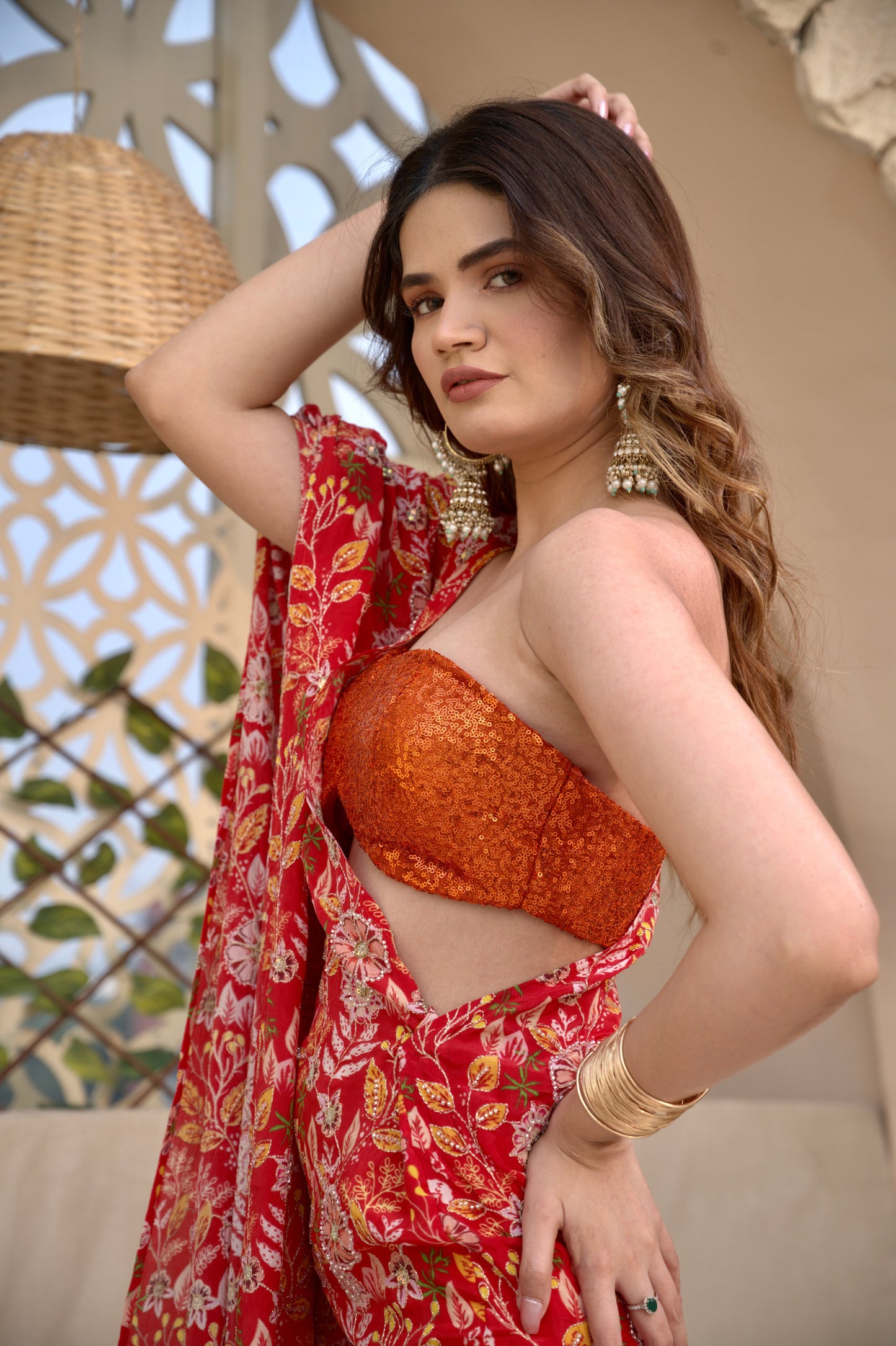 Red floral Tripti kaftan by Imagine By Shiwali featuring flowing fabric and vibrant floral patterns.