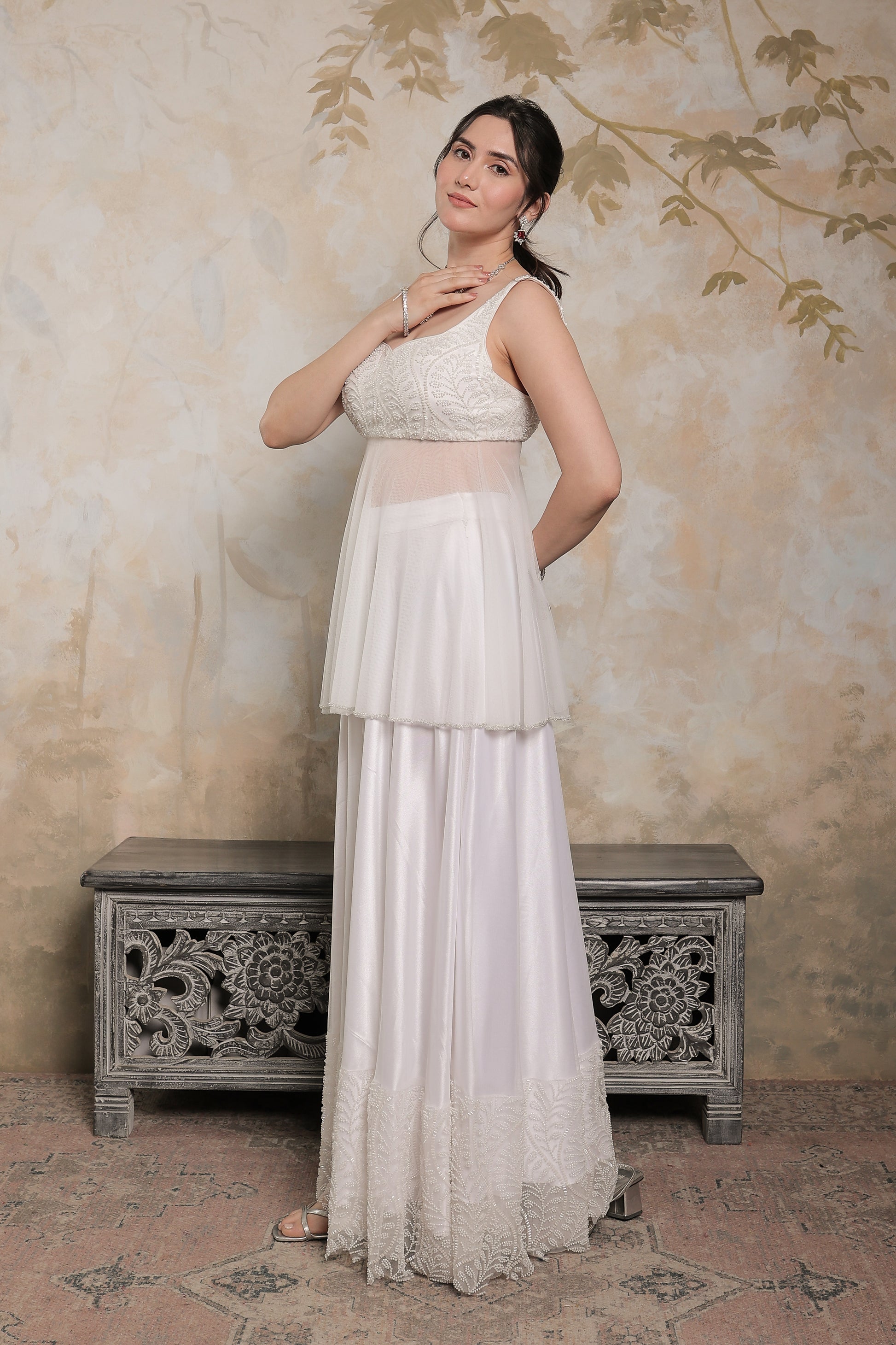 White Vaara Peplum Lehnga by Imagine By Shiwali featuring intricate embroidery and a traditional peplum design.