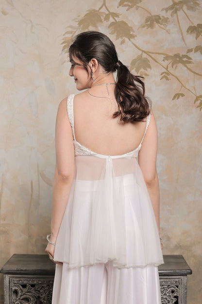 White Vaara peplum lehnga by Imagine By Shiwali featuring traditional embroidery and elegant fabric design.