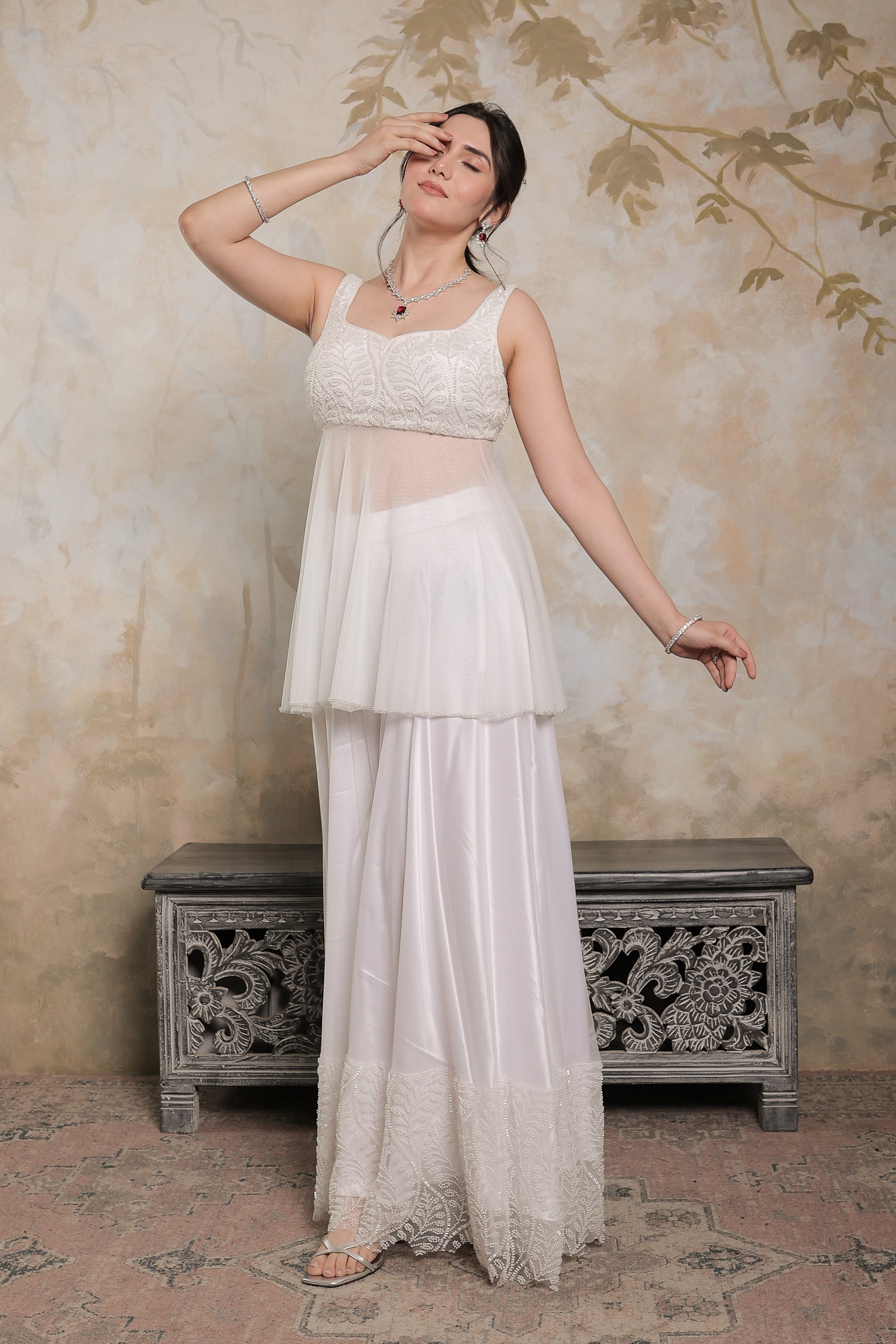 White Vaara Peplum Lehnga by Imagine By Shiwali featuring intricate embroidery and traditional design details.