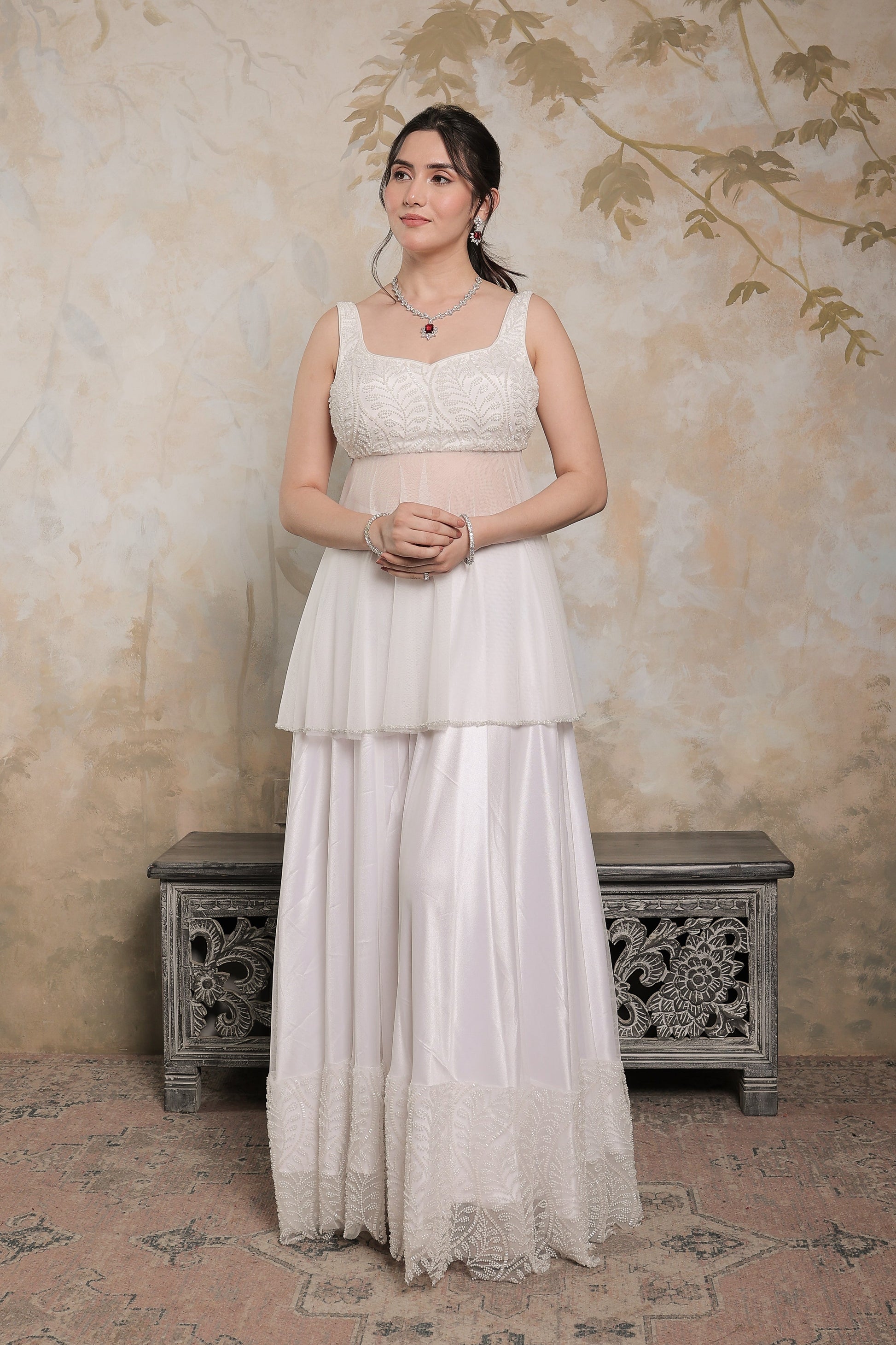 White Vaara peplum lehnga by Imagine By Shiwali featuring intricate embroidery and traditional design for elegant festive wear.